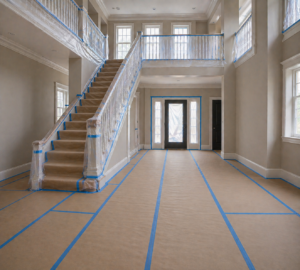 interior painting preparation in York PA with floors covered in paper and plastic protection on railings and trim